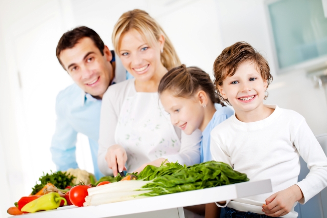 Happy family are preparing a healthy dinner at home.